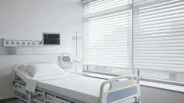 Commercial blinds installed in a hospital patient room for privacy and light control