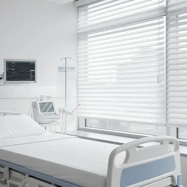 Commercial blinds installed in a hospital patient room for privacy and light control