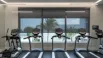 Modern gym interior with custom blinds on large windows, providing privacy, controlling light, and enhancing comfort and style