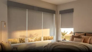 Light gray roller blinds filtering sunlight in a modern bedroom